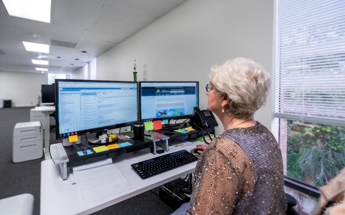 FL Registered Agent working in office at her desk.