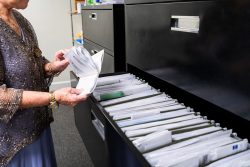 Office worker going through files.