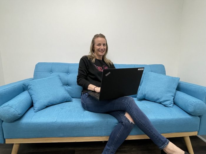 Florida office staff working on laptop while seated on couch